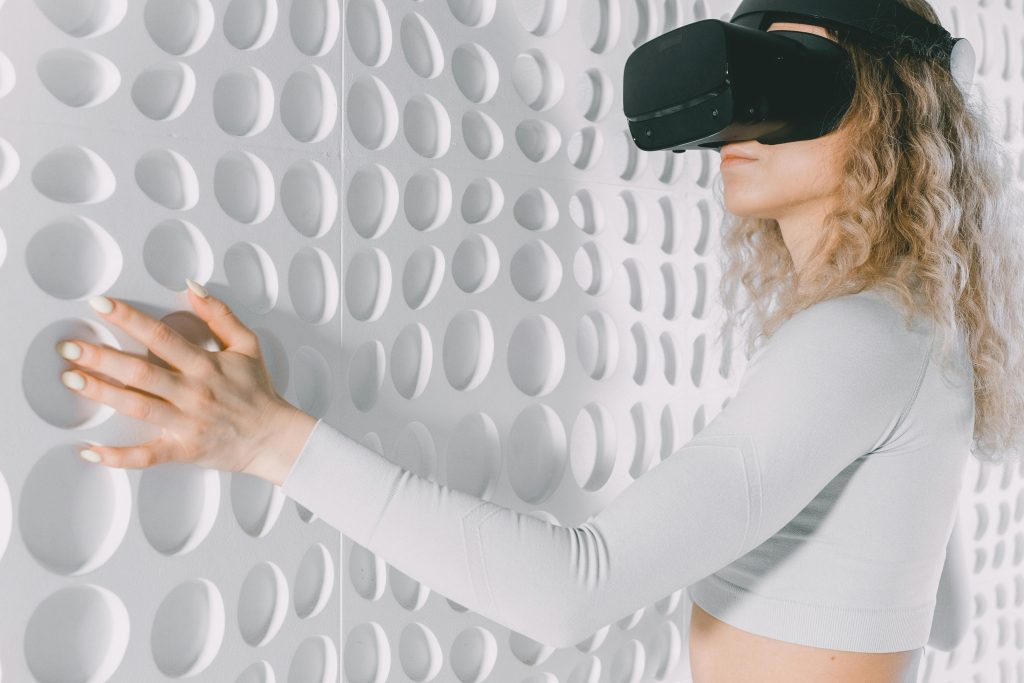 pexels-photo-7561874-7561874 Woman explores a white textured wall using virtual reality headset, capturing advanced tech and tactile perception.